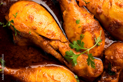 Chicken leg / drumstick curry or Murg Tangri/tangdi masala. Served in a bowl over moody background. Selective focus photo