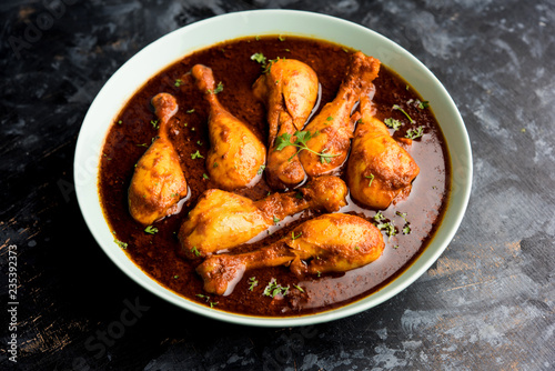 Chicken leg / drumstick curry or Murg Tangri/tangdi masala. Served in a bowl over moody background. Selective focus