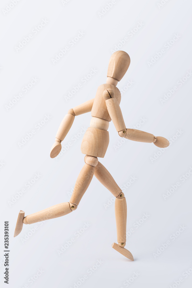running wooden mannequin isolated on white background running wooden mannequin isolated on white background