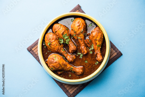 Chicken leg / drumstick curry or Murg Tangri/tangdi masala. Served in a bowl over moody background. Selective focus photo