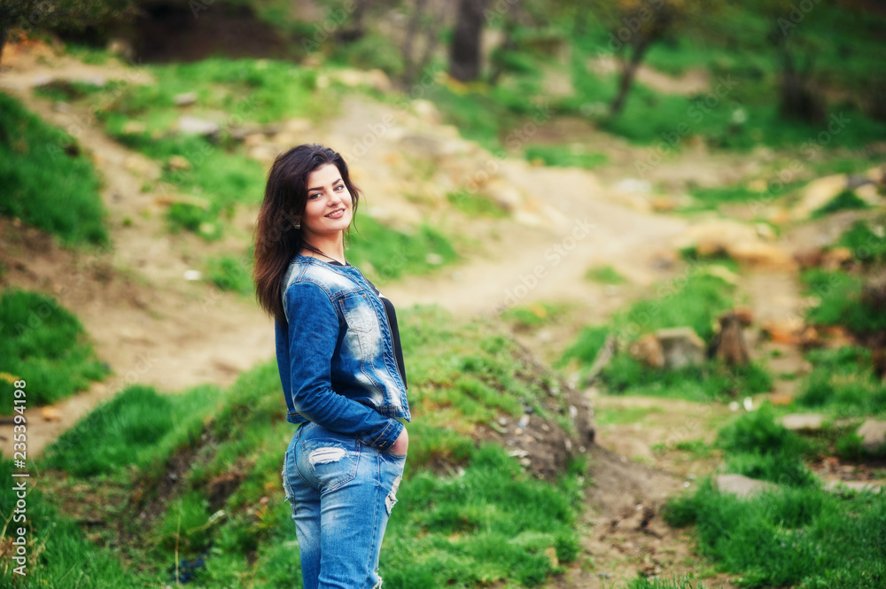 Young woman in jeans and jacket in Park Young woman in jeans and jacket in Park
