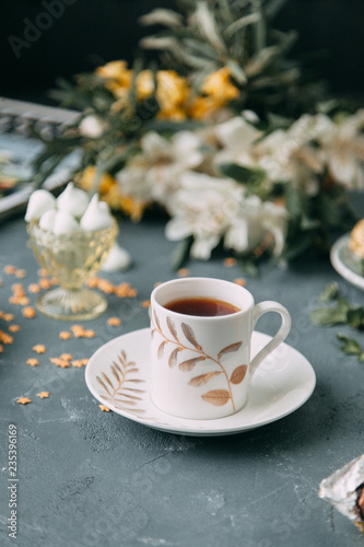 Coffee with mint on a wooden table. Food styling and desserts with flowers.