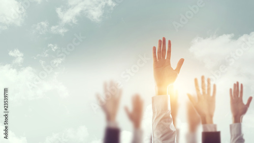 Businessman Hands raising for Participation with sunlight  Silhouette  copy space  vote