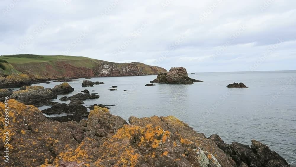 St Abbs Scotland rocky ocean shore pan. St Abbs a small fishing village on the southeastern coast of Scotland. Marina harbor, docks and boat mooring. St Abbs Scotland rocky ocean shore pan. St Abbs a small fishing village on the southeastern coast of Scotland. Marina harbor, docks and boat mooring.