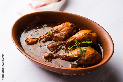 Chicken leg / drumstick curry or Murg Tangri/tangdi masala. Served in a bowl over moody background. Selective focus