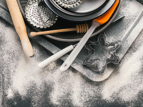 Baking utensils and accessories, cake tins. Christmas dark background