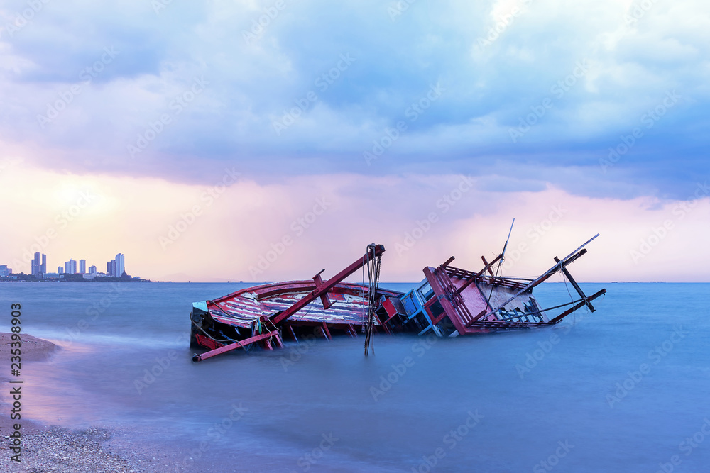 Shipwreck or wrecked boat on beach in the sunset. Beautiful Landscape. Night Pattaya Background. Thailand. Shipwreck or wrecked boat on beach in the sunset. Beautiful Landscape. Night Pattaya Background. Thailand.