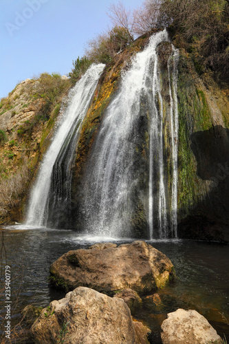 Waterfall landscape. Water stream of Mill waterfall - Height 21 meters. River Nahal Ayun. Nature Reserve and National park  The Oven . This location is very popular for tourists in Israel