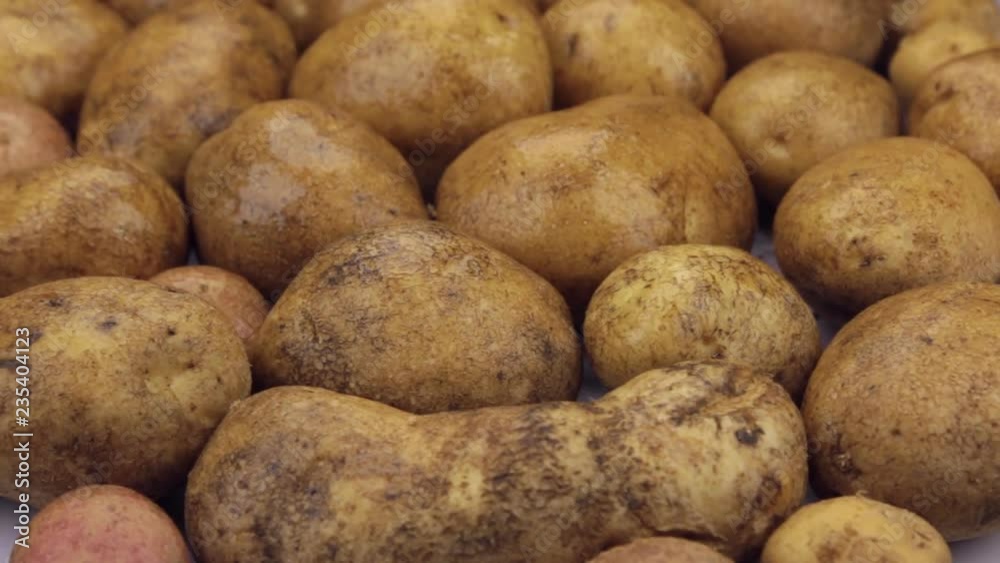 Raindrops falling on rotating potatoes. Close-up. Raindrops falling on rotating potatoes. Close-up.