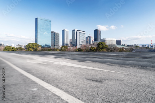 Panoramic skyline and modern buildings with empty road in Osaka