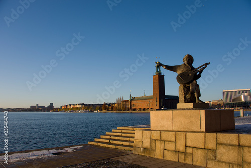 Statue and Town City Hall in Stockholm at the Riddarfjarden fjord on Riddarholmen island