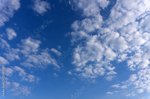 amazing white clouds of unusual shape on blue sky background .
