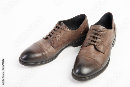 Man's brown leather shoes on white background isolated