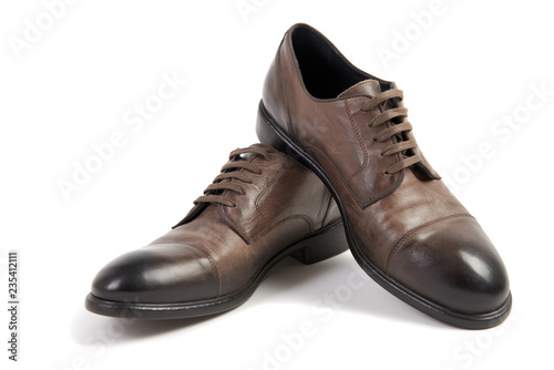 Man's brown leather shoe on white background isolated