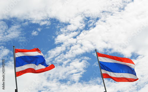 Thailand flag on sky / couple two of thailand flag on post with clouds and blue sky background