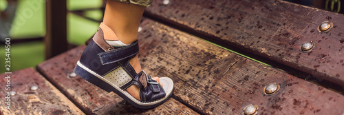 Konstfotografi children's orthopedic shoes on the boy's feet BANNER, long format