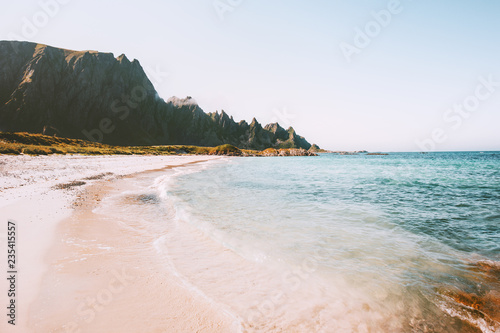 Sea beach landscape in Norway idyllic empty sandy coast view summer travel vacations nature scenery seaside and mountains rocks photo