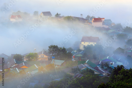 Fantastic foggy village in the sunlight in Dalat, Vietnam