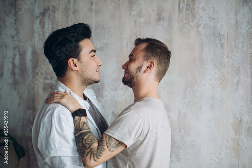 Canvas Print Hot gay couple at the sweet moment of love enjoying closeness and passion kissin