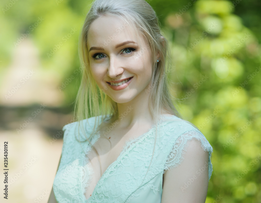 Summertime portrait of young woman in the park. Summertime portrait of young woman in the park.
