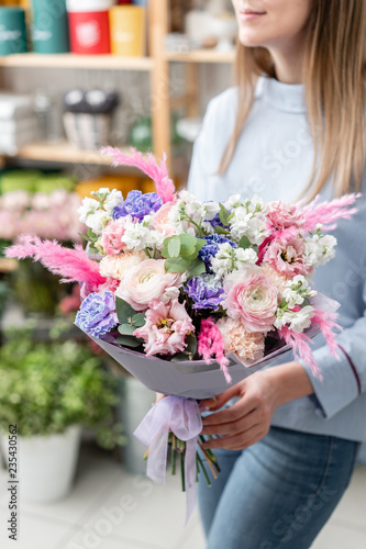 European floral shop. Bouquet of beautiful Mixed flowers in woman hand. Excellent garden flowers in the arrangement , the work of a professional florist.