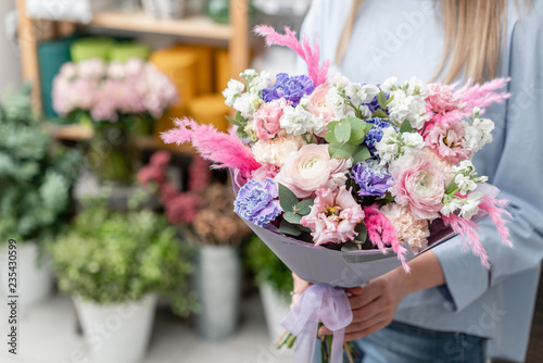 Fototapeta Naklejka Na Ścianę i Meble -  European floral shop. Bouquet of beautiful Mixed flowers in woman hand. Excellent garden flowers in the arrangement , the work of a professional florist.