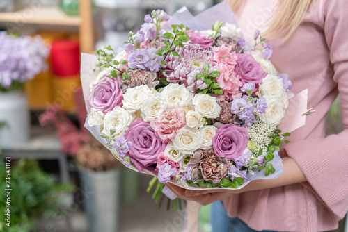 Fototapeta Naklejka Na Ścianę i Meble -  European floral shop. Bouquet of beautiful Mixed flowers in woman hand. Excellent garden flowers in the arrangement , the work of a professional florist.