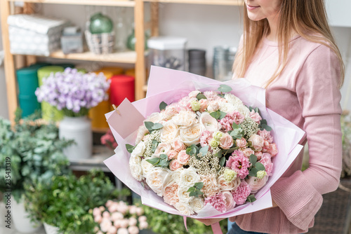 European floral shop. Bouquet of beautiful Mixed flowers in woman hand. Excellent garden flowers in the arrangement , the work of a professional florist.