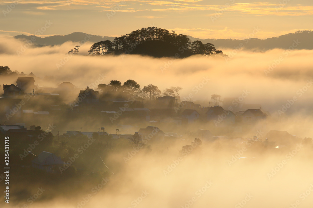 Fototapeta premium Fantastic foggy village in the sunlight in Dalat, Vietnam