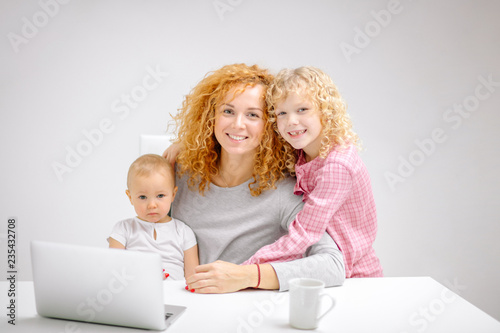 friendly family posing to the camera. close up photo. warm feeling between parent and cjildren photo