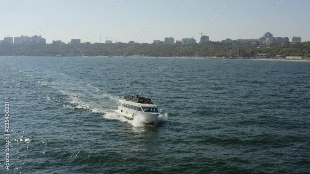 Aerial view of tourist boat sail not far from coastal city at sunny day drone Aerial view of tourist boat sail not far from coastal city at sunny day drone