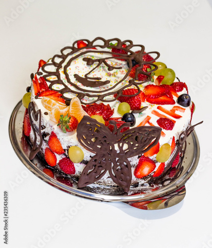 Home made chocolate cake with cream abd fruits photo