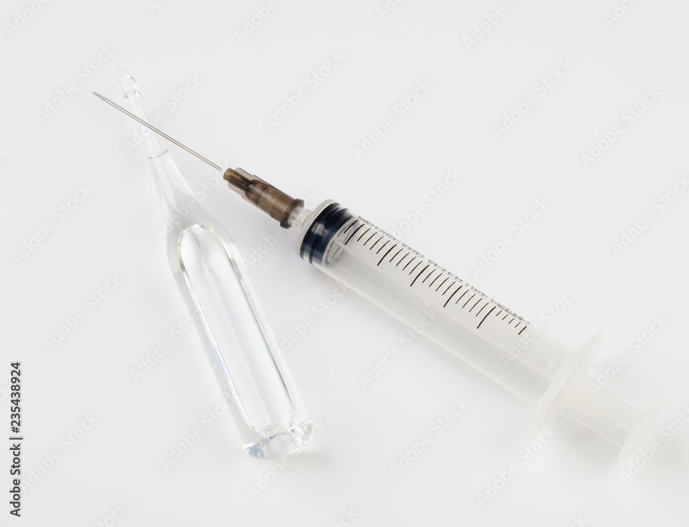 Medical syringe and glass ampoule with medicine on white background. Medical syringe and glass ampoule with medicine on white background.