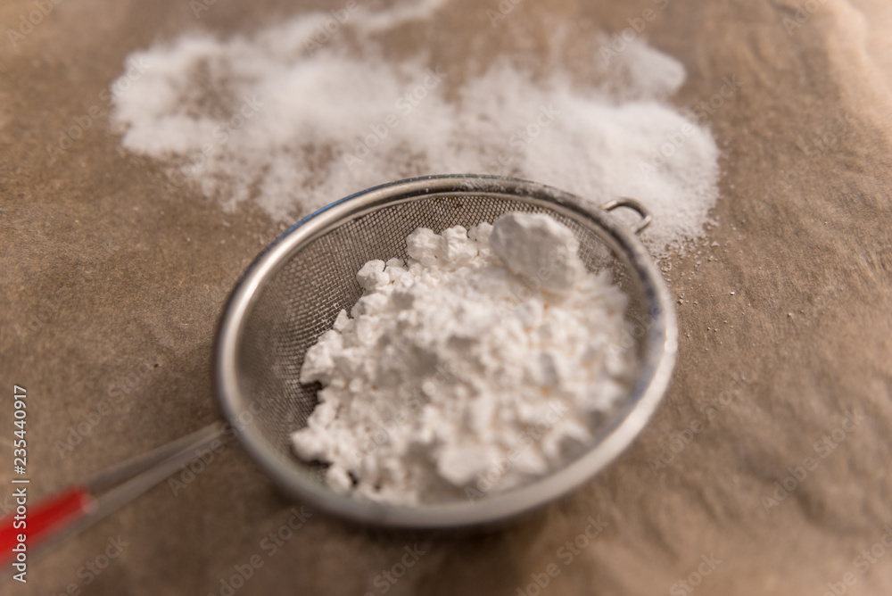 powdered sugar in a strainer powdered sugar in a strainer