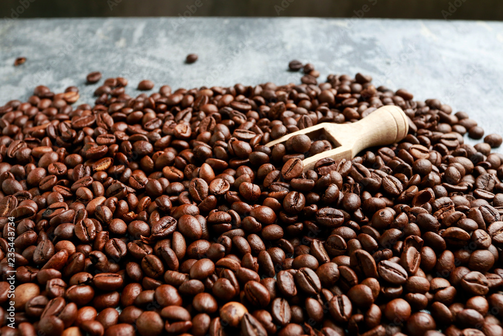 Fototapeta premium Coffee beans background and wooden scoop.