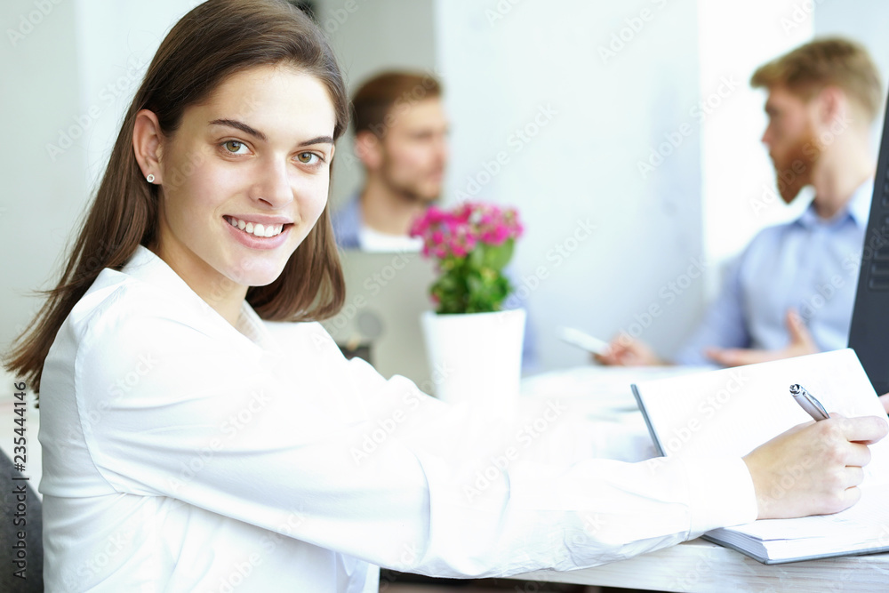 business woman with her staff, people group in background at modern bright office indoors. business woman with her staff, people group in background at modern bright office indoors.