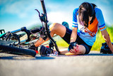 accident clashed on young woman bicyclist in hurt and injured at knee of leg and arms, after accident clashed, with mortal wound and bleeding of blood flow on the surface of street road