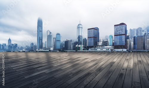 Panoramic skyline and modern buildings with empty boardwalk in Hong Kong