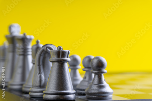 Chess pieces on the chess board with selective focus and crop fragment. Business and motivation concept. Copy space
