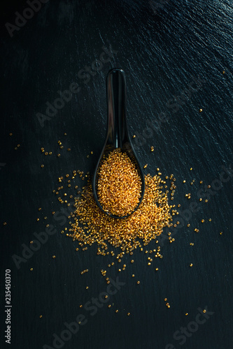 Golden beads over black background