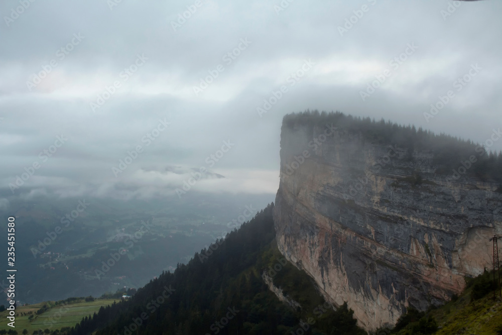 View of a big rock on top of a mountain, valley, trees and beautiful nature in fog. The image is captured in Trabzon/Rize area of Black Sea region located at northeast of Turkey.