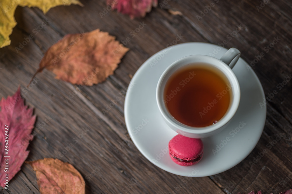 Autumn still life of colorful leaves, a Cup of tea, on an old brown wooden table Autumn still life of colorful leaves, a Cup of tea, on an old brown wooden table