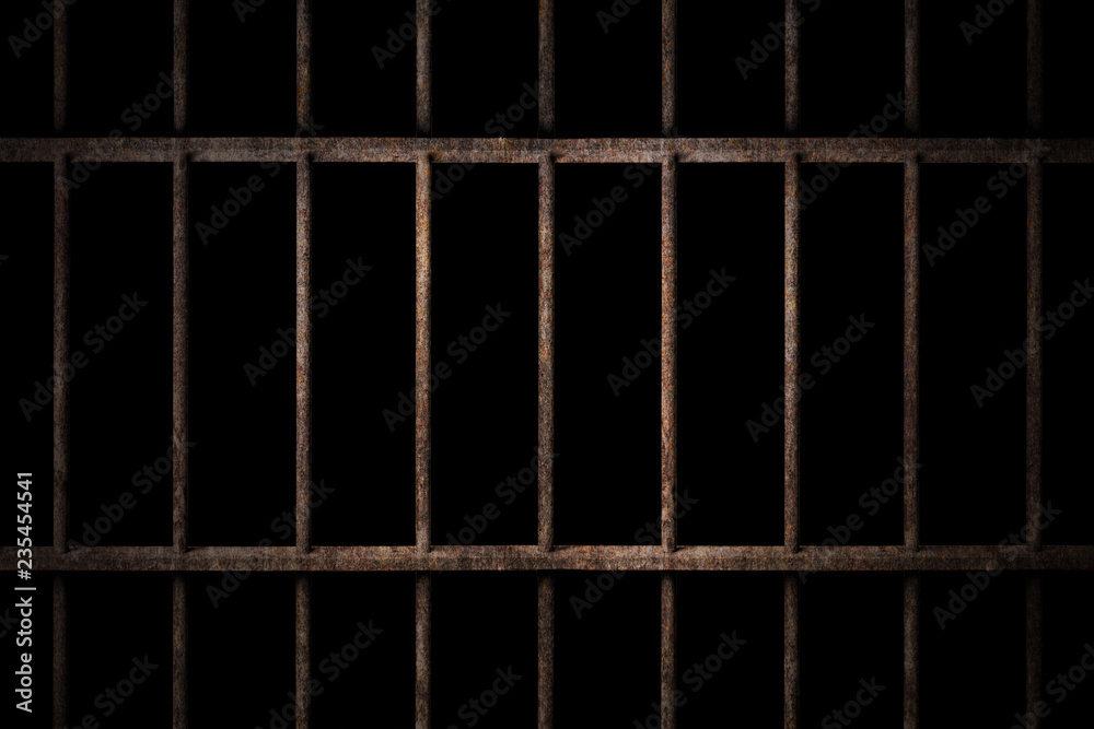 Old prison rusted metal bars cell lock with dark and bright in the jail Old prison rusted metal bars cell lock with dark and bright in the jail