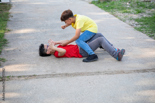 kids fighting on street in the garden at school © SHUTTER DIN