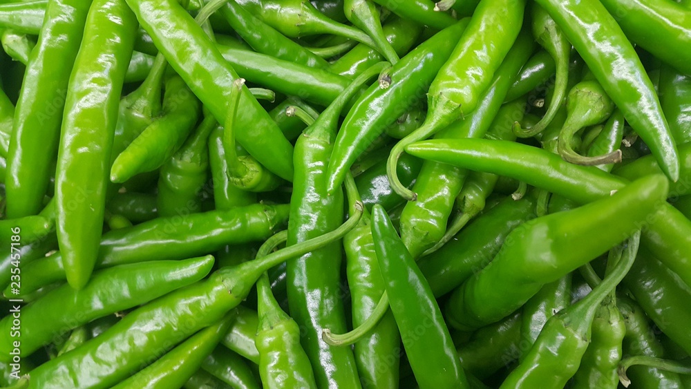 pile of green chili pepper in harvest season placed in a market pile of green chili pepper in harvest season placed in a market