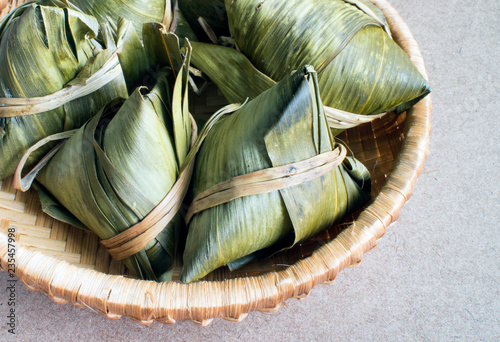 Vietnamese traditional food for may 5th, is double five festival or tet doan ngo, sticky rice cake in green leaf, also call banh u tro with pyramidal shape photo