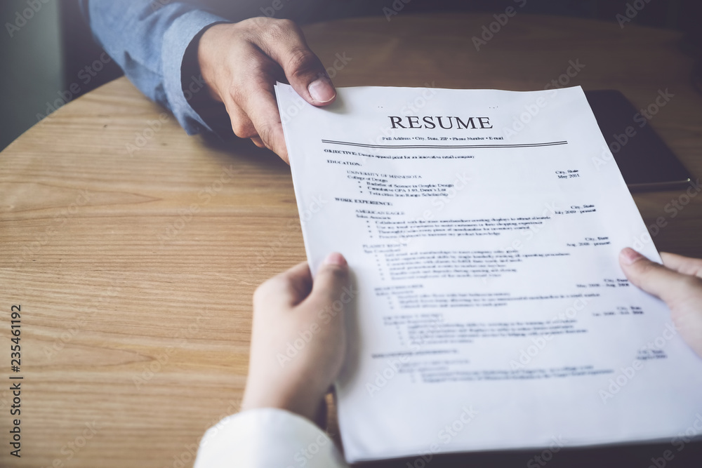 Obraz premium Applying for a job, filing a resume Experience, candidates stand the document with the company hr to get elected to work.
