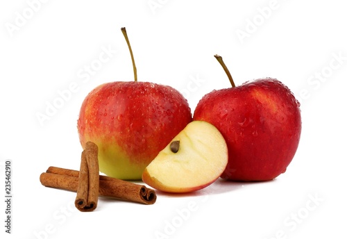 
Red ripe apple and aromatic cinnamon sticks on white background