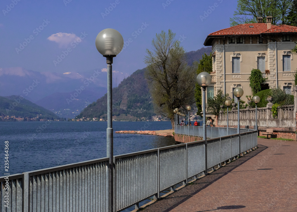 long pedestrian promenade facing the Lugano Lake. Porto Ceresio, Italy