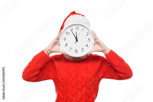 Late new year and christmas shopping girl with big wall clock in santa claus hat on isolatad white background photo